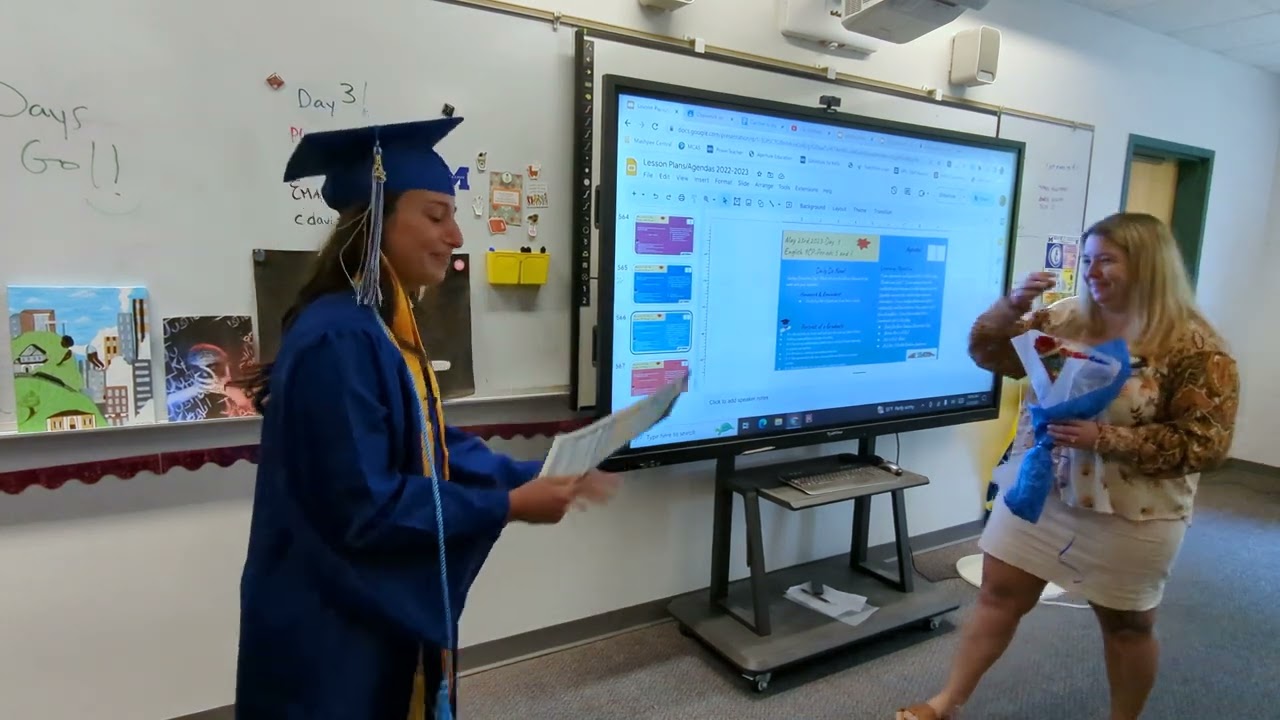 Ava DeSimone presents a Life Impact Diploma to Mrs. Davis