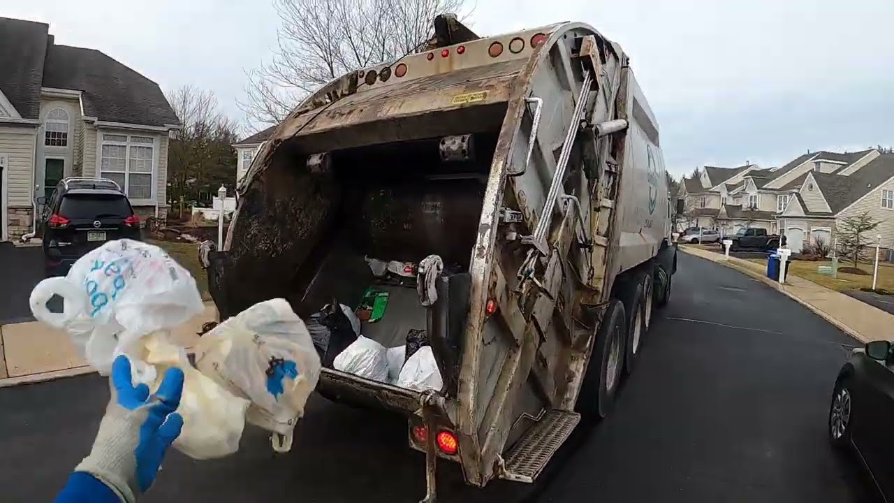 Garbage man POV: Manual trash on a Mack MR McNeilus rear loader garbage truck Part 1