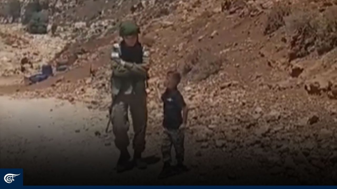 Palestinian child confronts an Israeli soldier