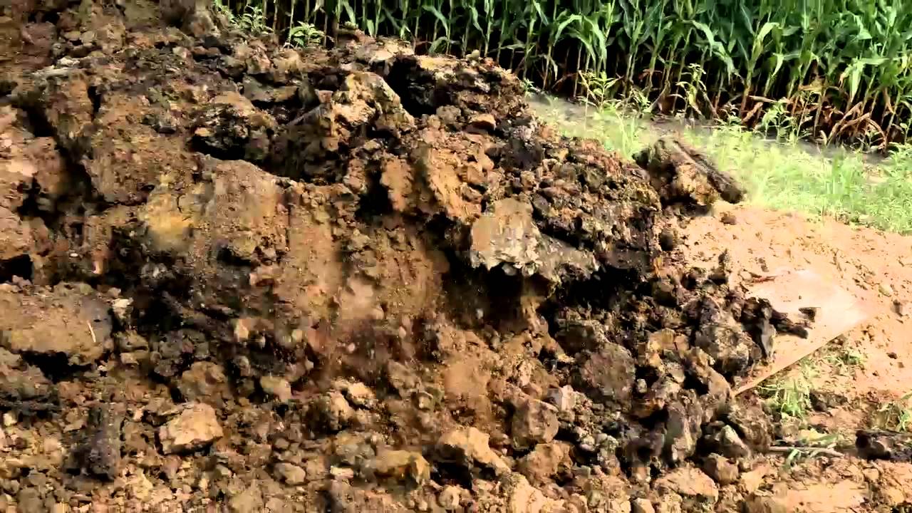 Cat&reg; 325F Hydraulic Excavator at Work Trenching and Stockpiling