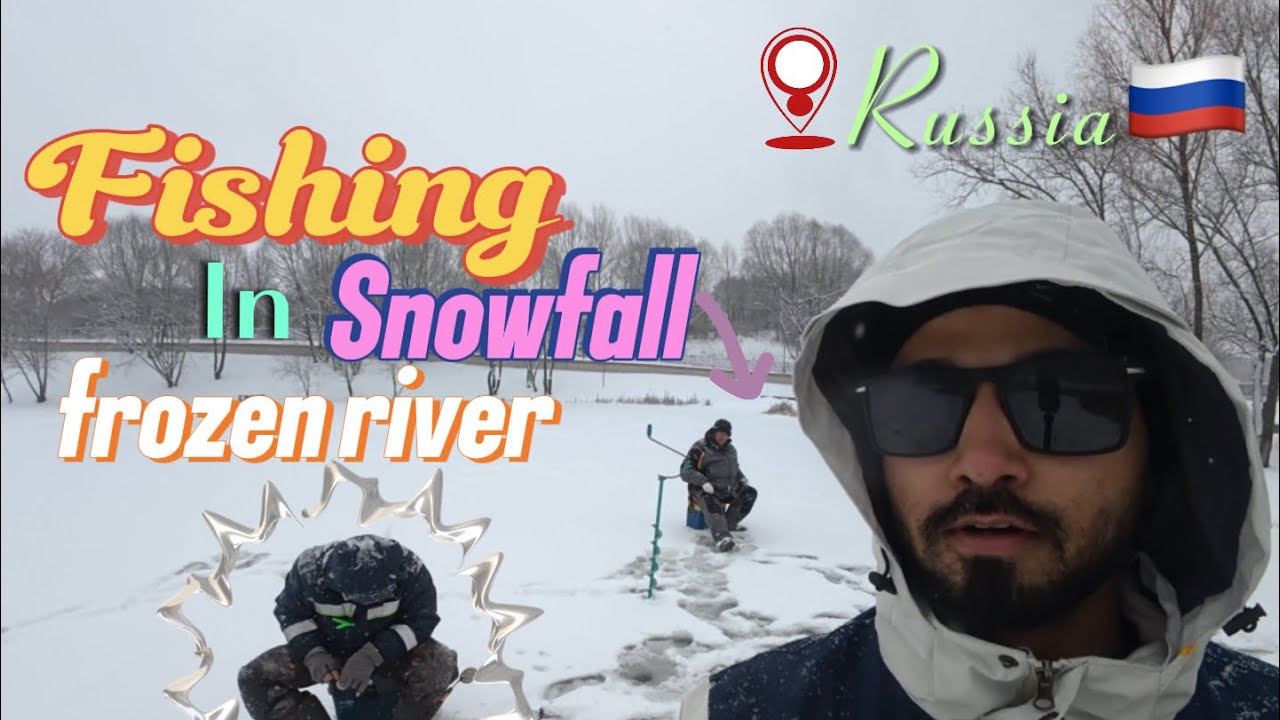 Fishing in snowfall frozen river