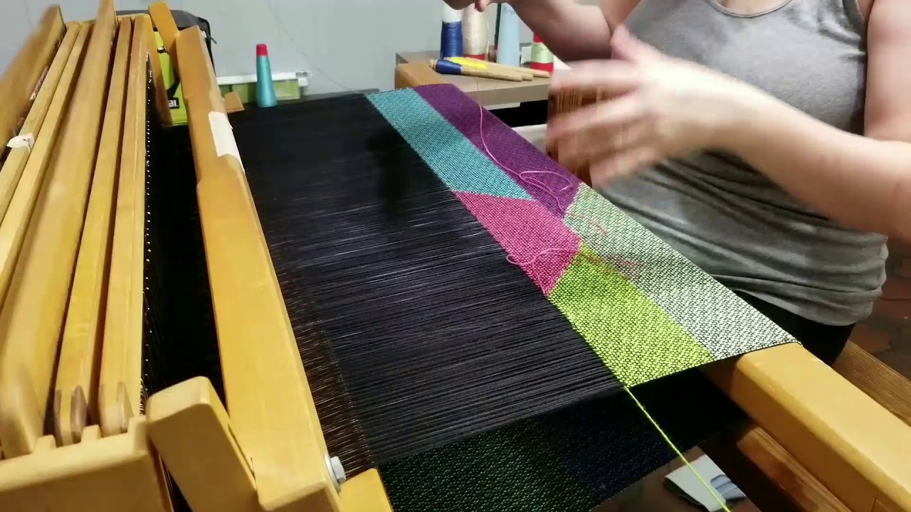 Weaving triple clasped weft on a floor loom.