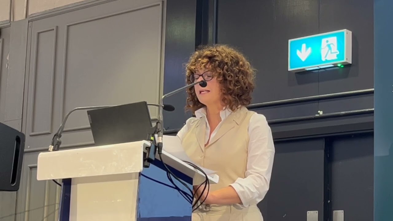 Niamh Sheridan addresses fellow community workers at 'In Our Words'