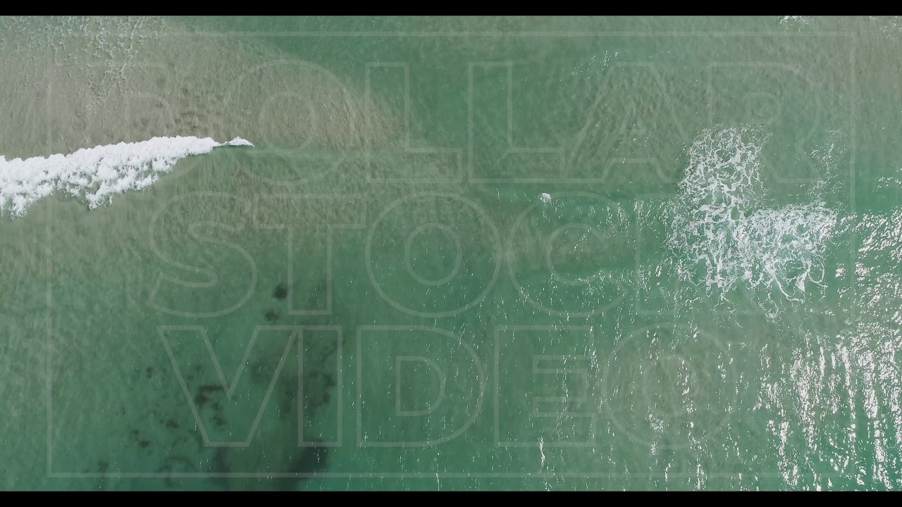 Aerial of Light Blue Ocean Waves on Beach | Stock Drone Video Over Ocean Waves | 4k 29.97fps