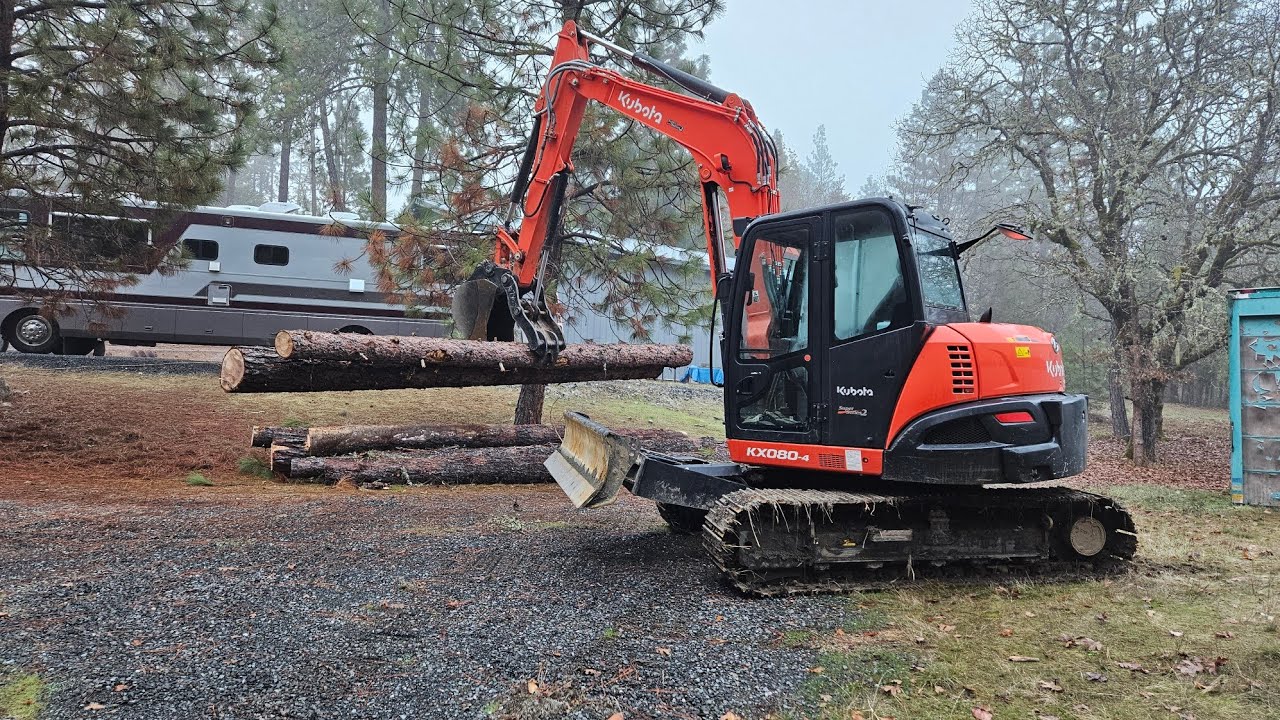 Sawmill logs loaded with the Kubota KX 080 4 excavator