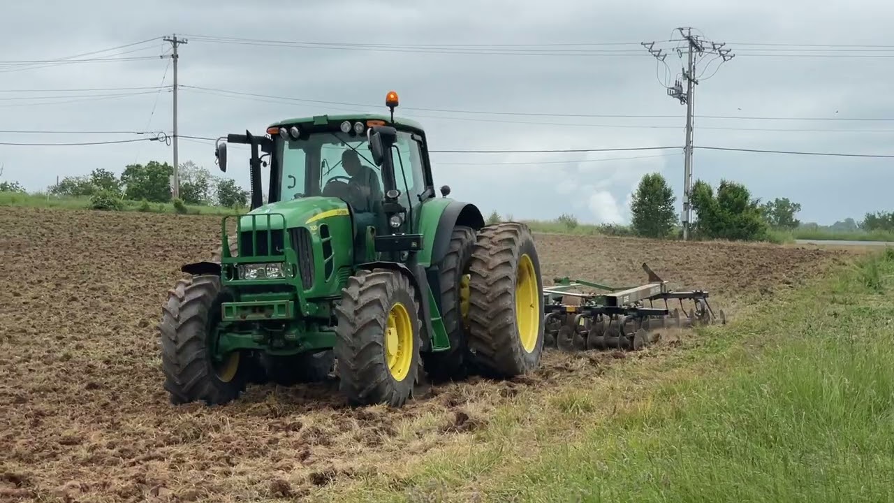John Deere tractor discing the Bowen Arrow vineyard soil.