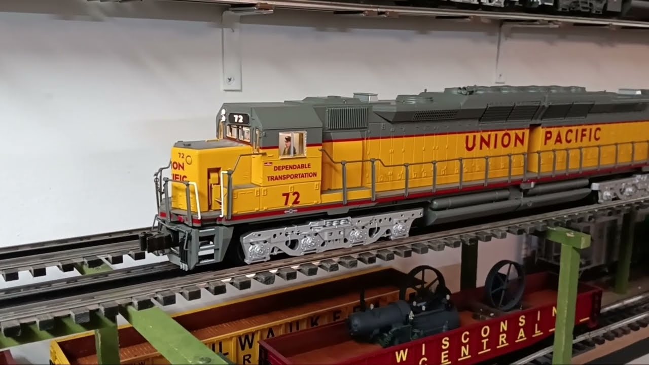 Паровоз Lionel DD35 тянет платформы с помощью тягачей, напечатанных на 3D-принтере.