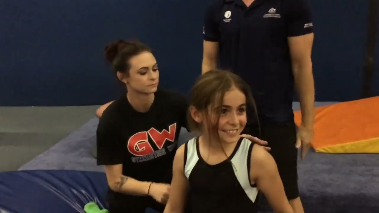 Spotting technique to control the head on back tumbling skills