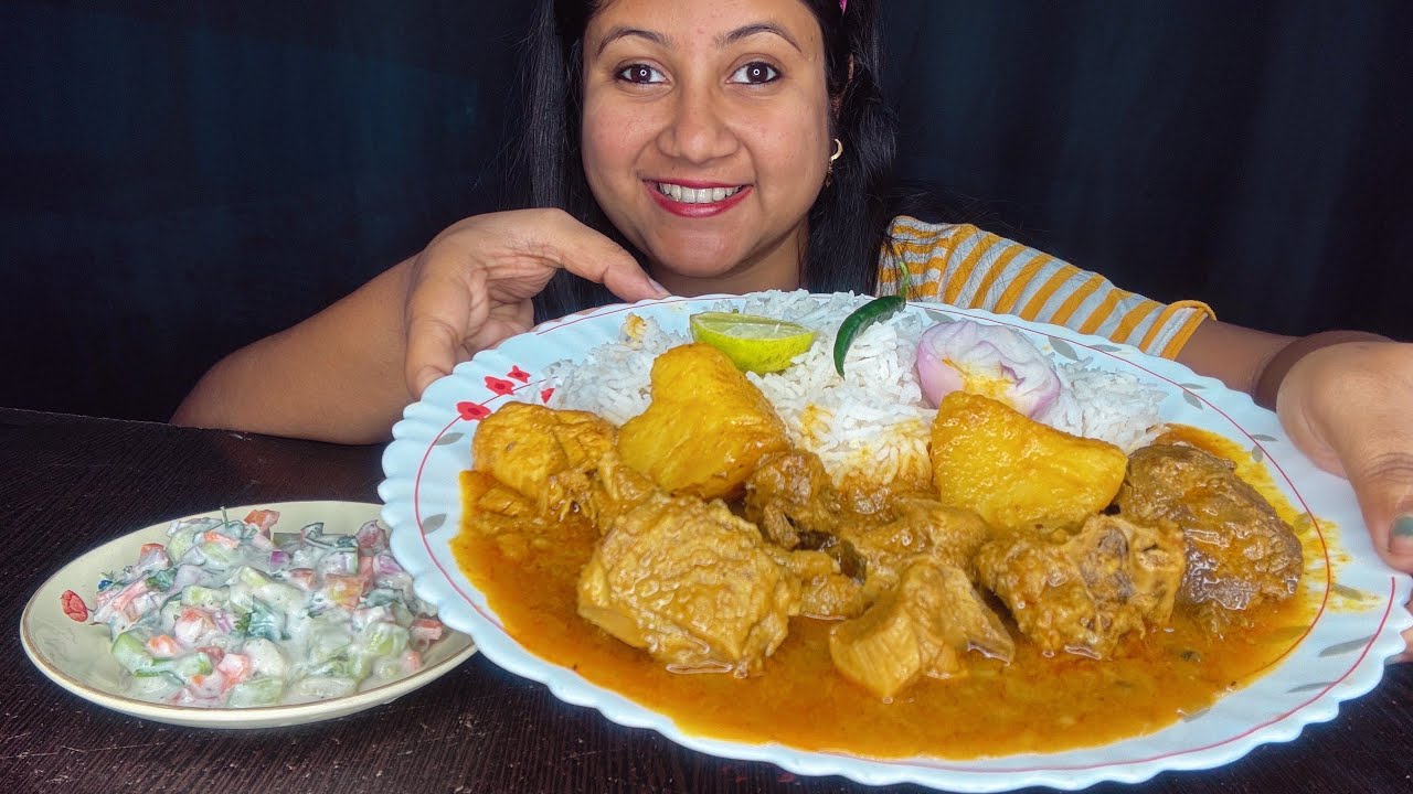 Eating chicken curry , basmati rice , salad 