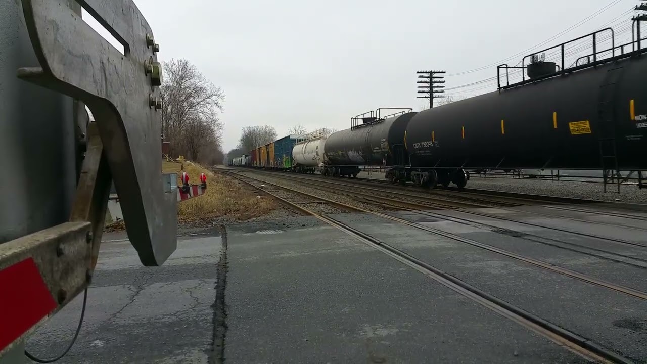Norfolk Southern, Almost hit by the sidewalk gate.  Placard #3295 Hydrocarbons, liquid