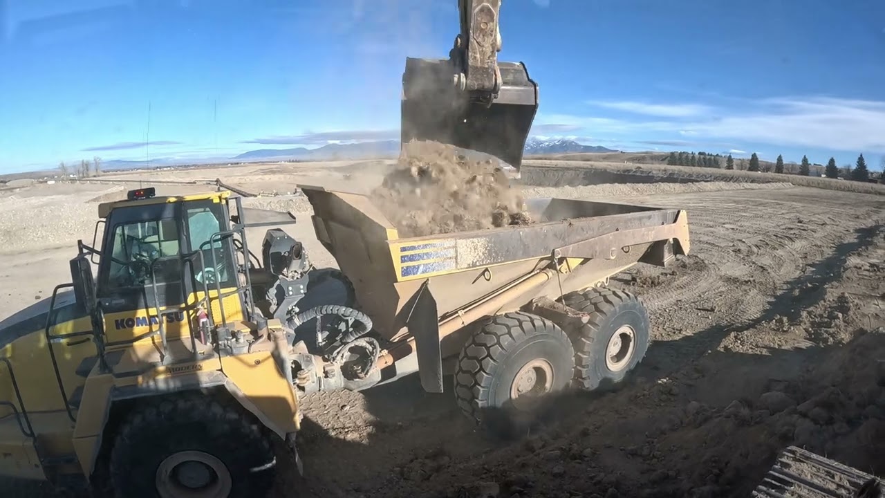 Komatsu PC490 excavator loading Volvo and Komatsu haul trucks