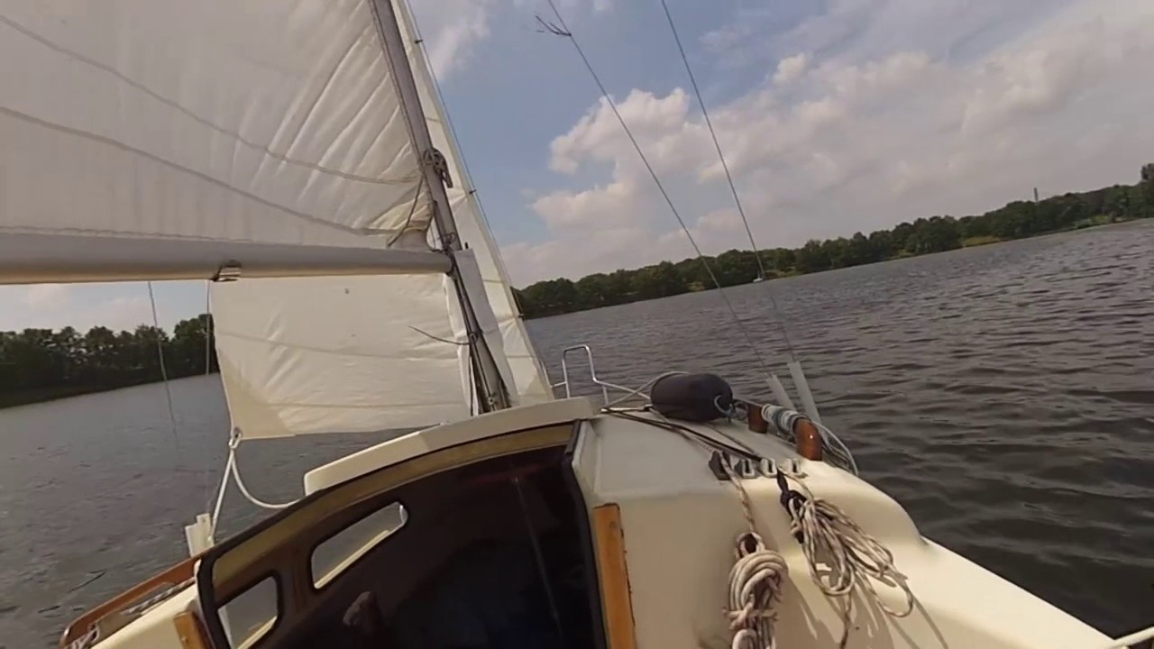 Tacking on the Odra River. Single-handed sailing. 18 ft sailboat Ra-Cruiser.