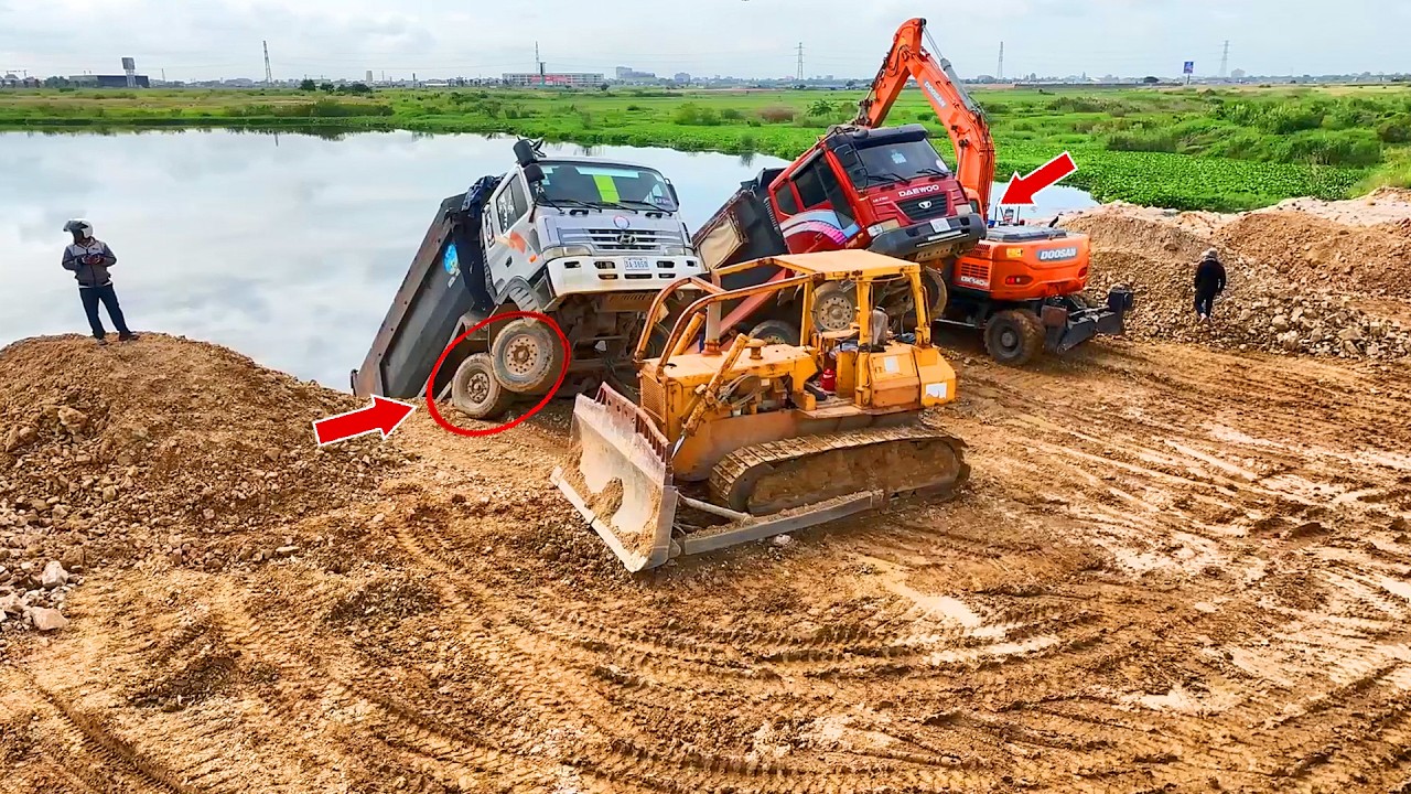 OH Dump truck that collapsed due to filling soil into a lake.Rescued by a skilled 2 bulldozer driver