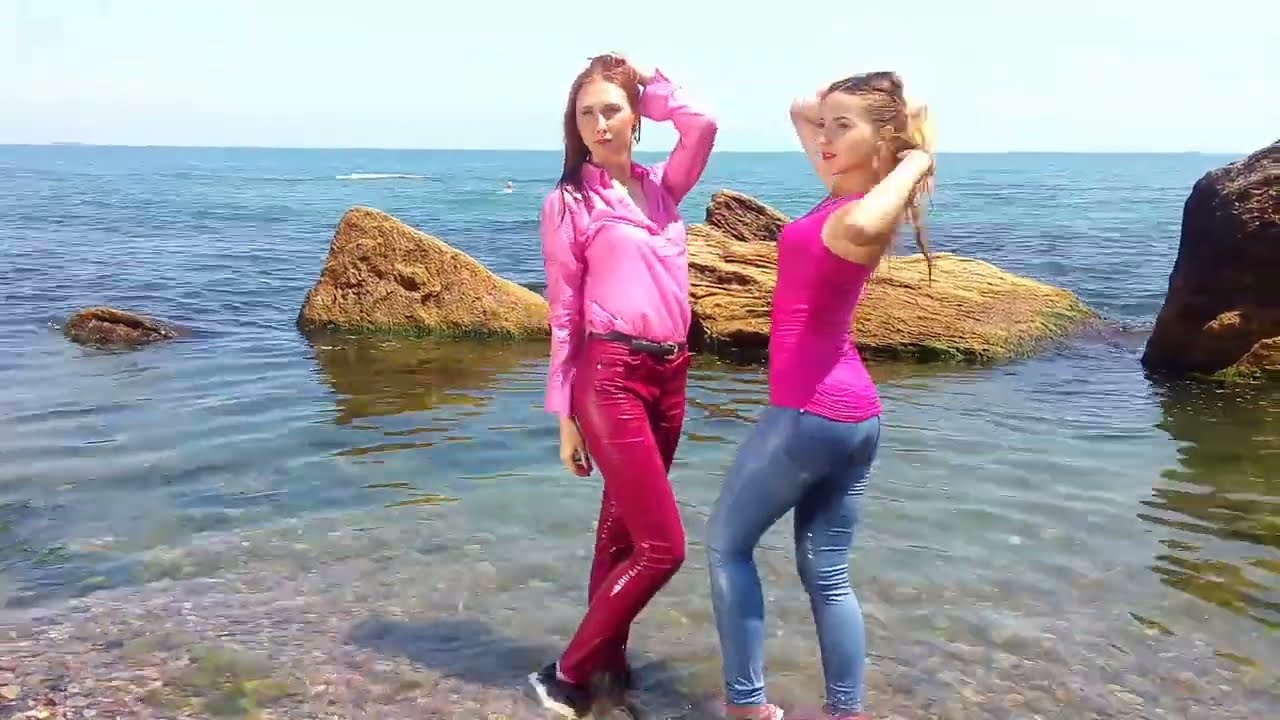two girls get wet in jeans and clothes