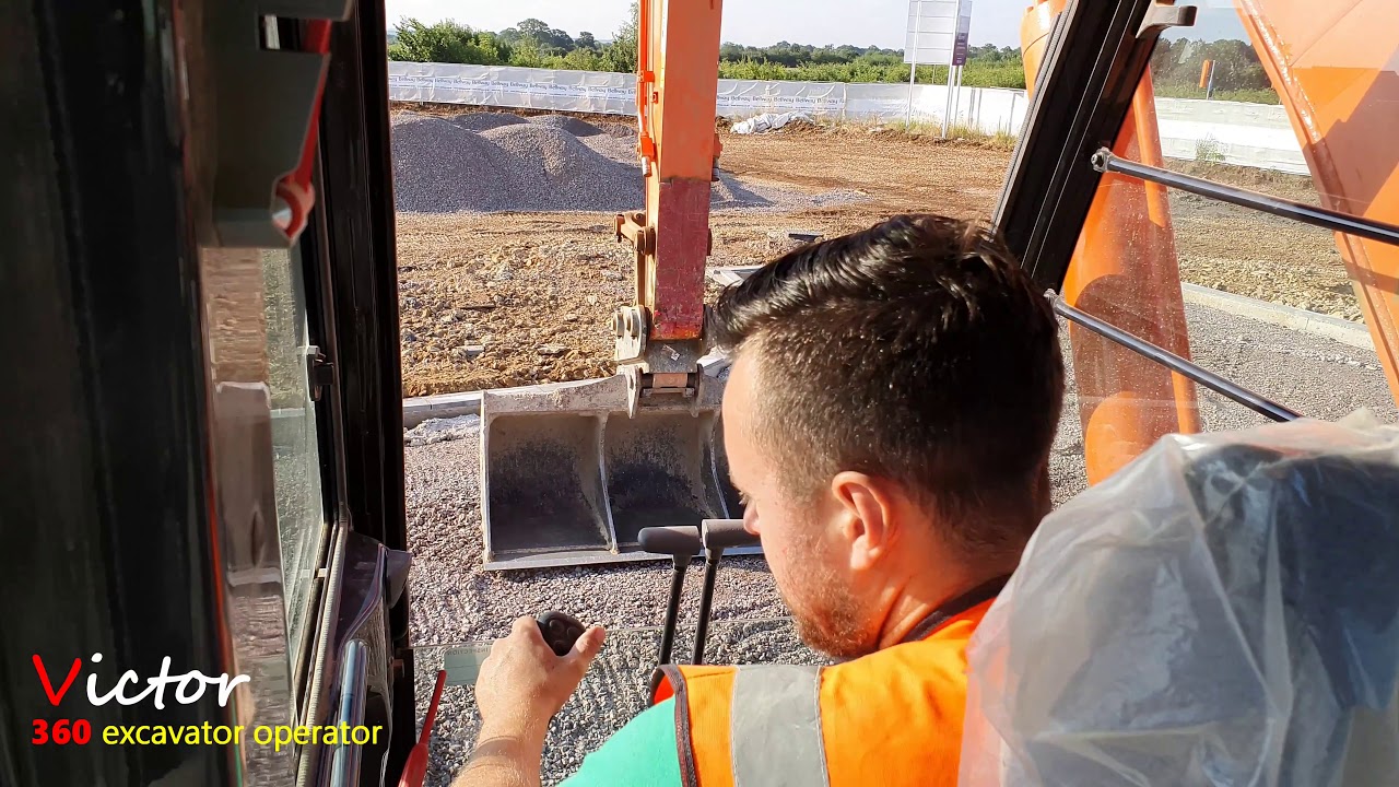excavator tidying the road using a  (HITACHI ZAXIS 210 lc )