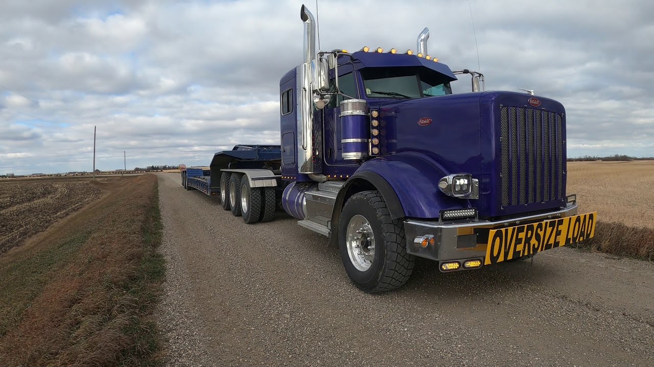 Heavy haul Tri-Drive Peterbilt Moving an Oversize Caterpillar D7 Dozer Show Trucks