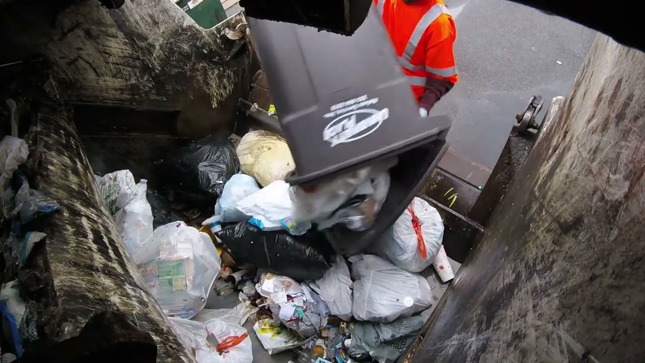 McNeilus Rear Loader Packing Garbage