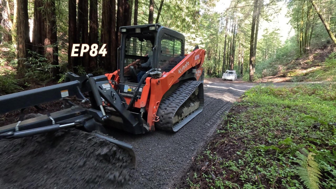 Grading a private driveway. Filling ruts, sloping for drainage and spreading new base rock. EP84