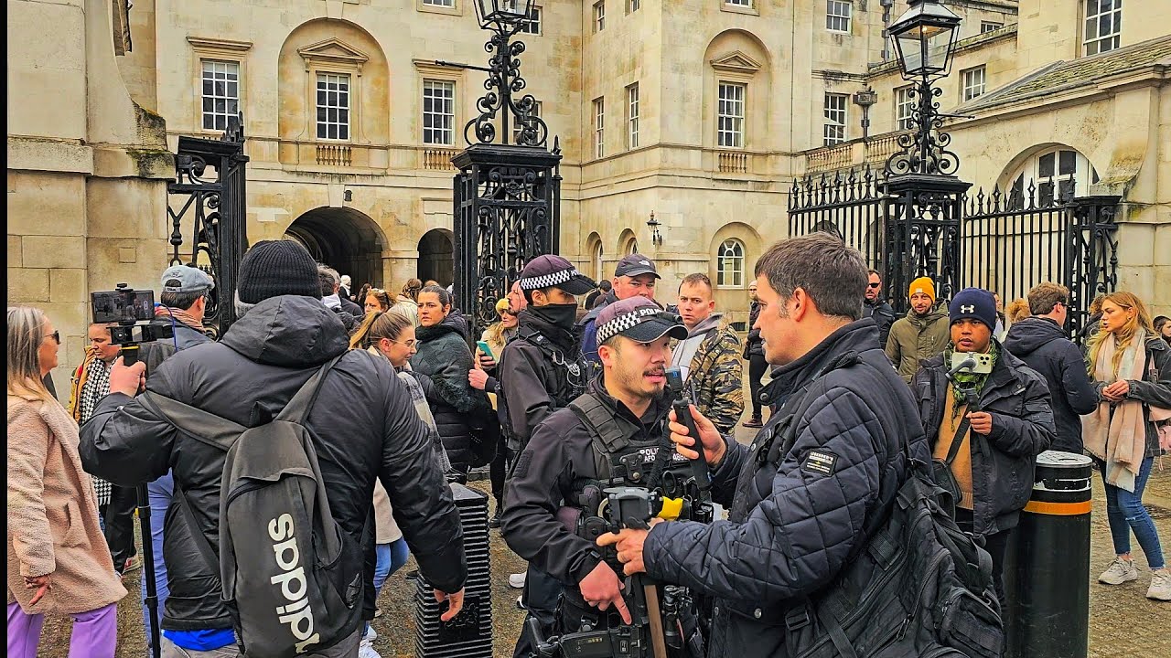 POLICE INTERVENE following fisticuffs at Horse Guards as The King's Guard looks bemused!