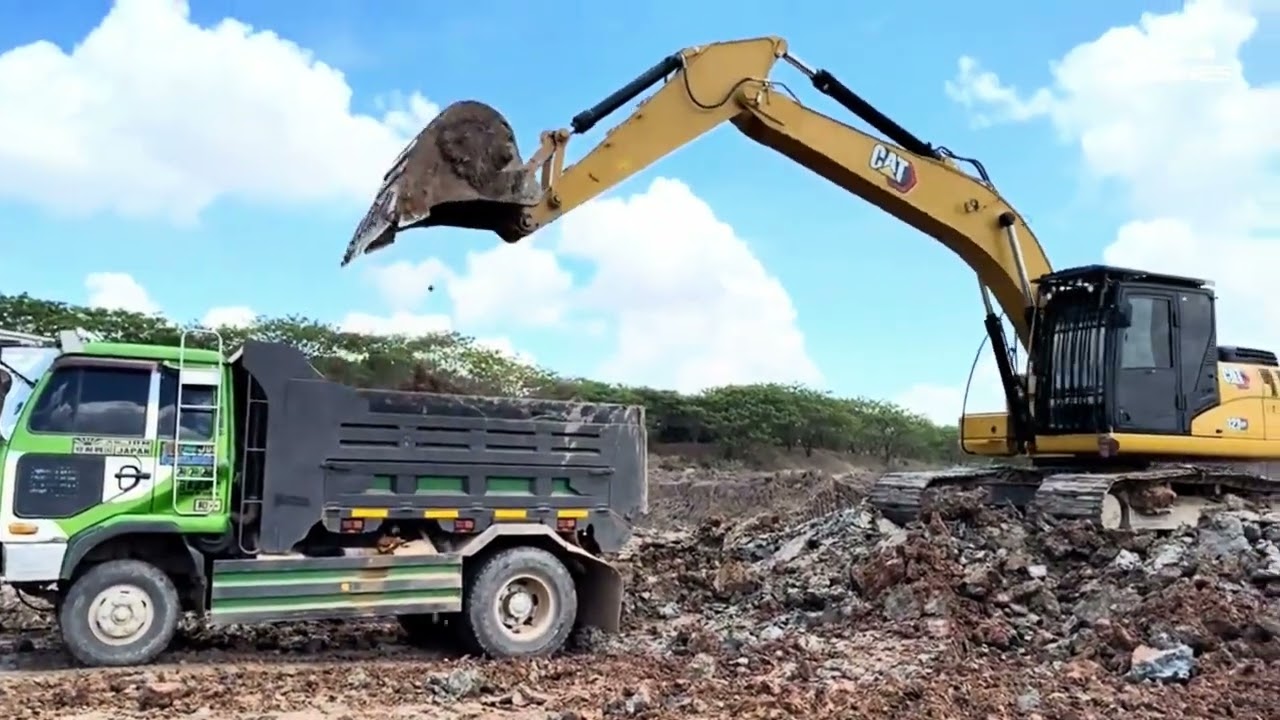 Caterpillar 323GC excavator digging mud at the lakeside with heavy dump truck 