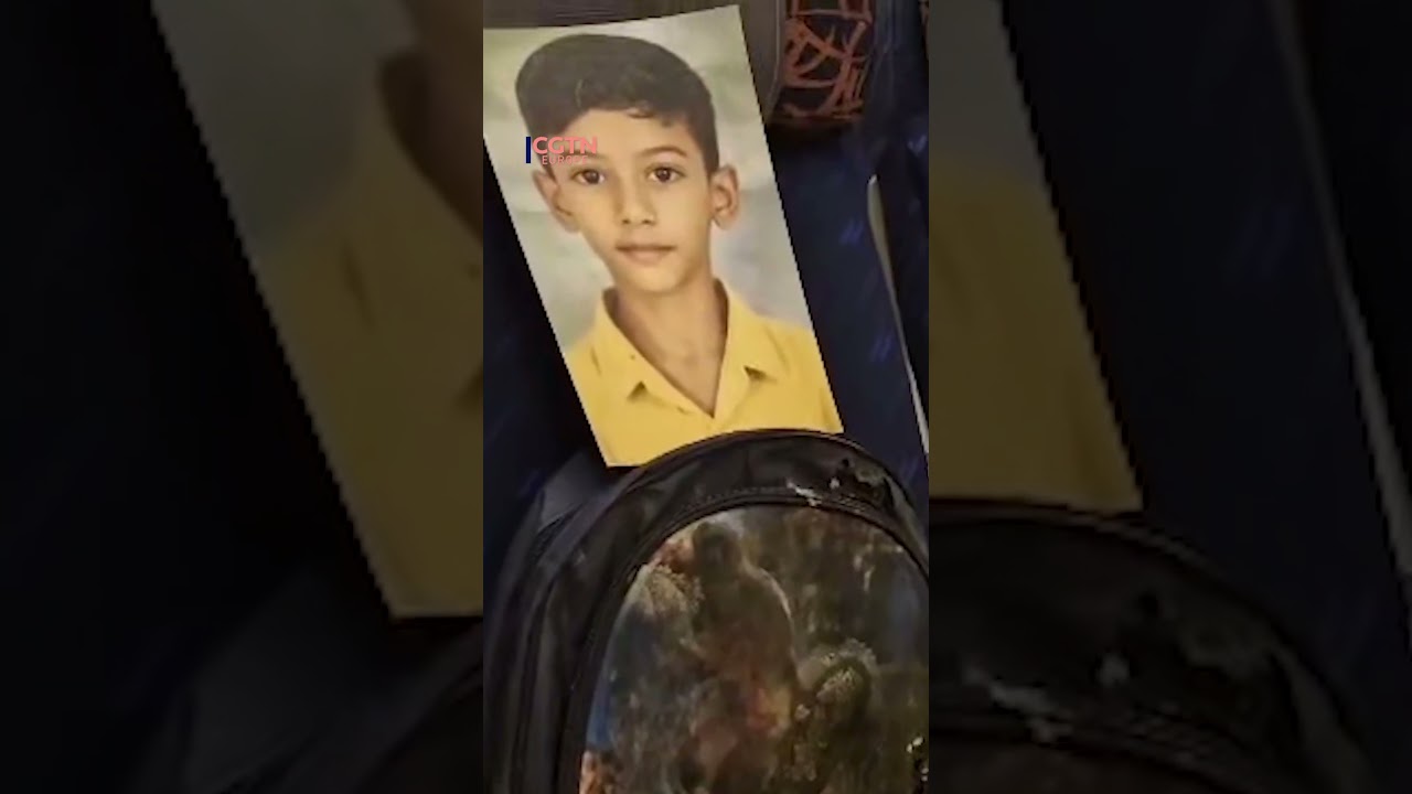 Iranian delegation carries photos of student victims on flight