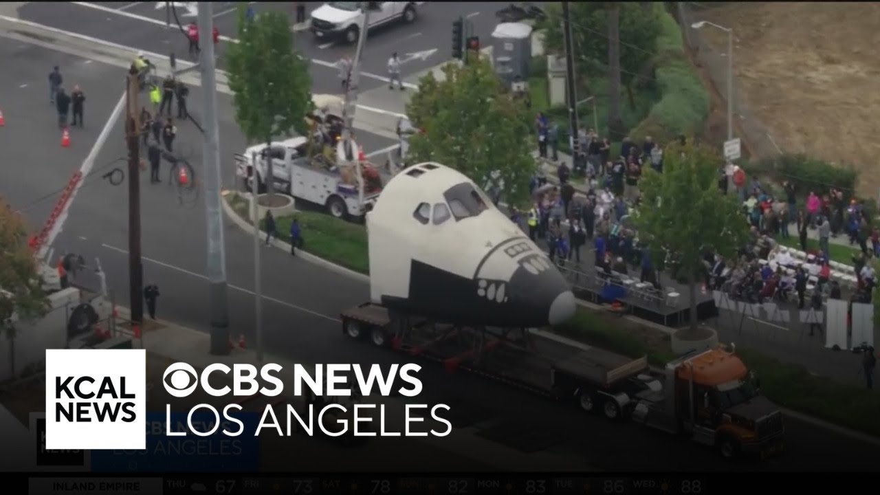 Downey residents watch in awe as shuttle prototype moves through city streets