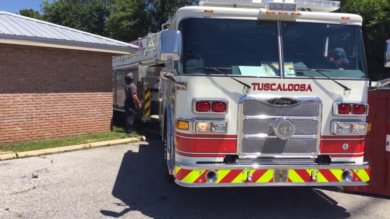 Tiller Truck Makes Tight Turn Between Bldg and Dumpster - Tractor Drawn Aerial