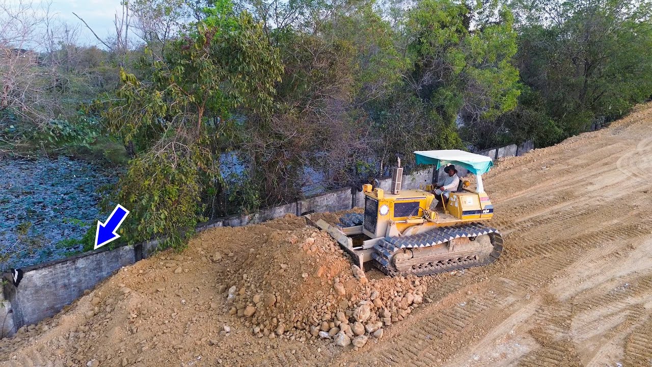 Nice Skill Operating Bulldozer Komatsu Pushing soil and stones leveling landfill