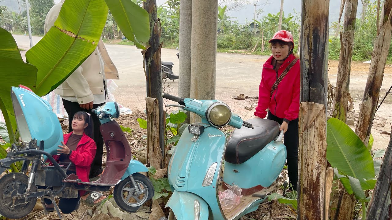 The girl repaired the abandoned electric scooter in the banana grove for $50.