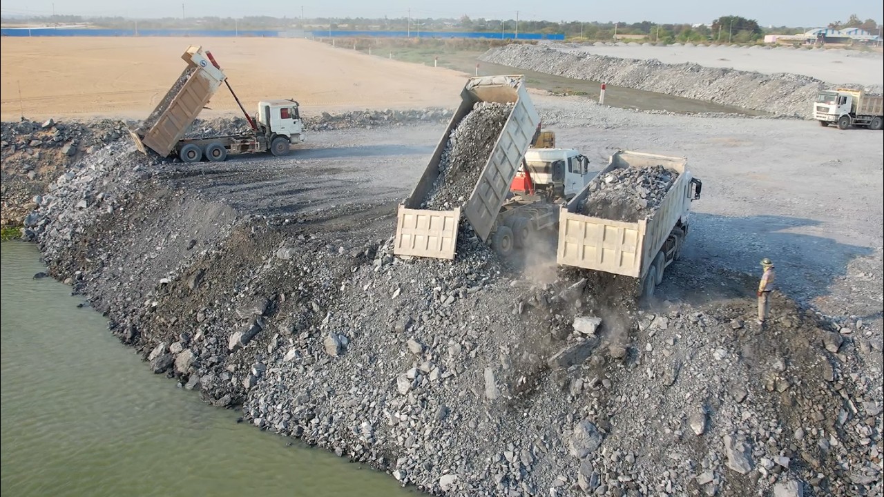 Interesting!!Wheeloader Pushing Stone Into Water With Dump Trucks 10 Wheel Unloading Stone Filling