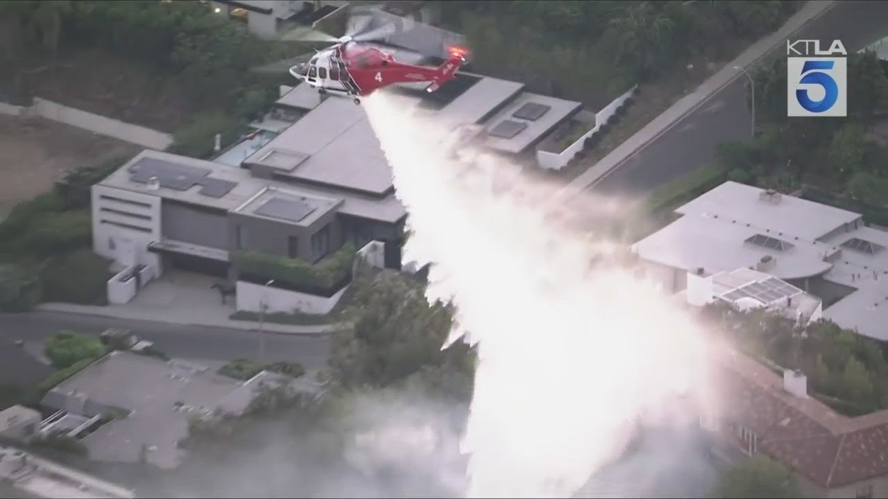 Fire crews battle brush fire in Hollywood Hills