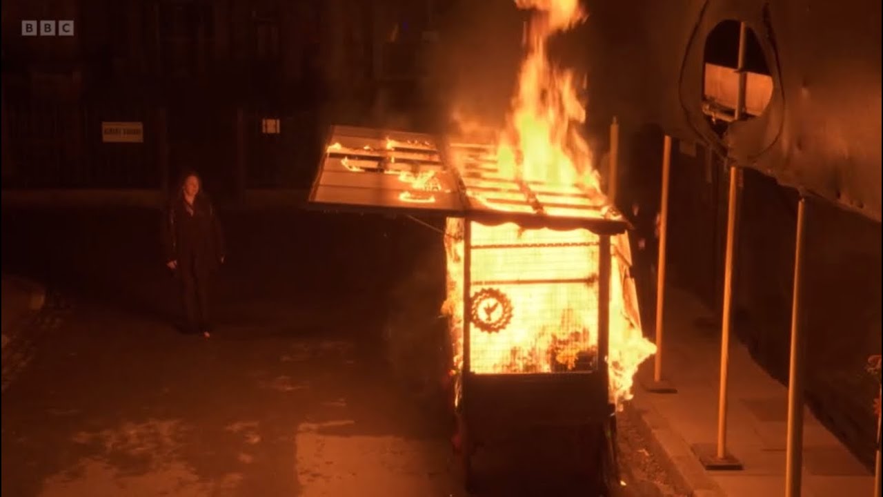 Eastenders Stacey rushes out of the front door as Martin’s market stall has been set on fire scene
