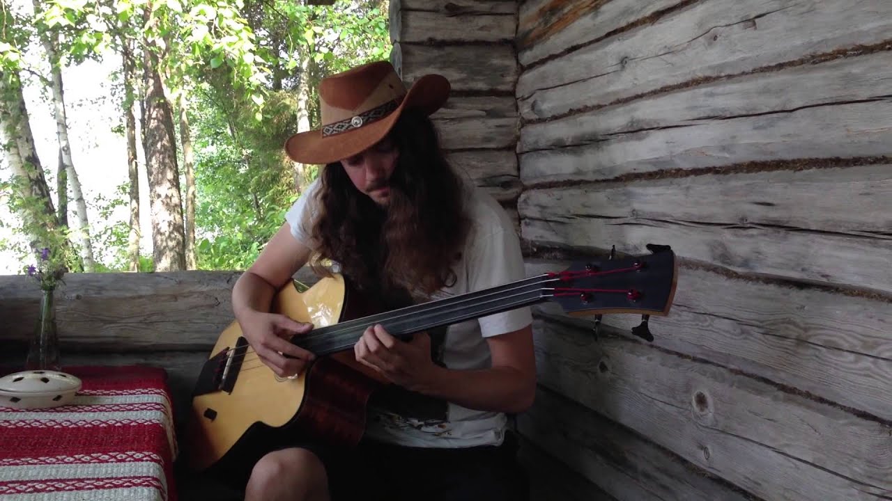 Lauri Porra plays Brian Eno on acoustic bass guitar by the lake