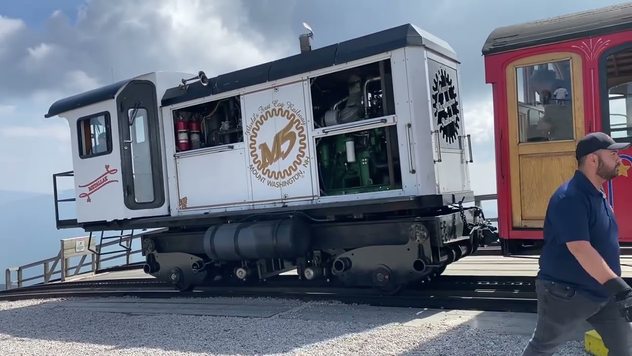 Two Cog Railway Engines & Cars Leave The Summit Of Mt Washington In New Hampshire