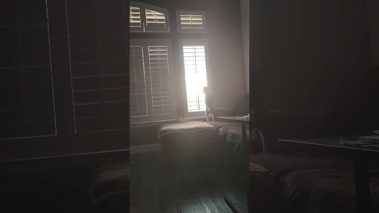 Juliette opening the blinds