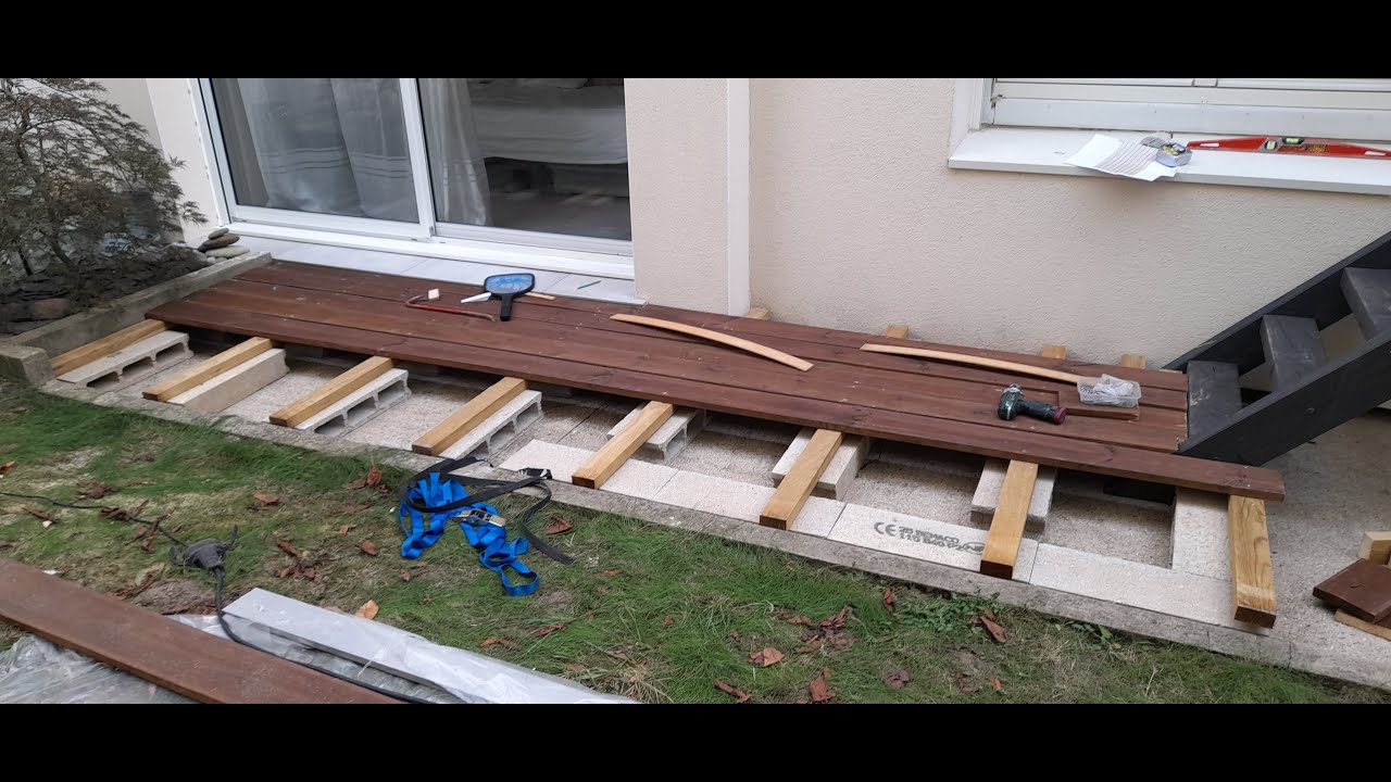 Fabrication d'une terrasse en bois et en gazon synthétique à petit budget.