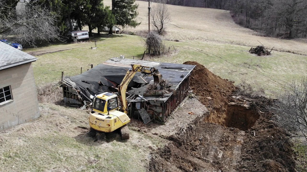 Tearing down a Barn with an Excavator