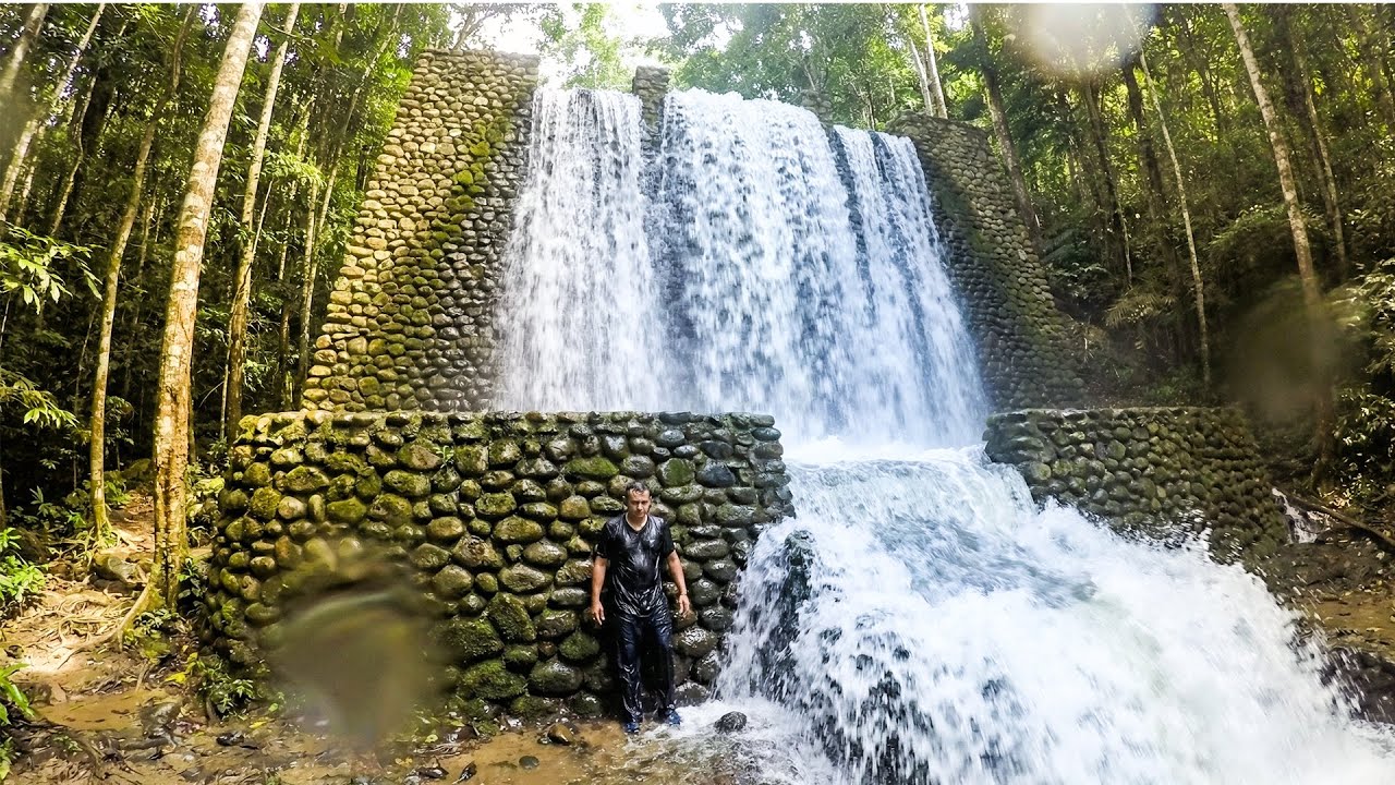 Building a Stone Waterfall With Giant Rocks While Water Spills Sideways