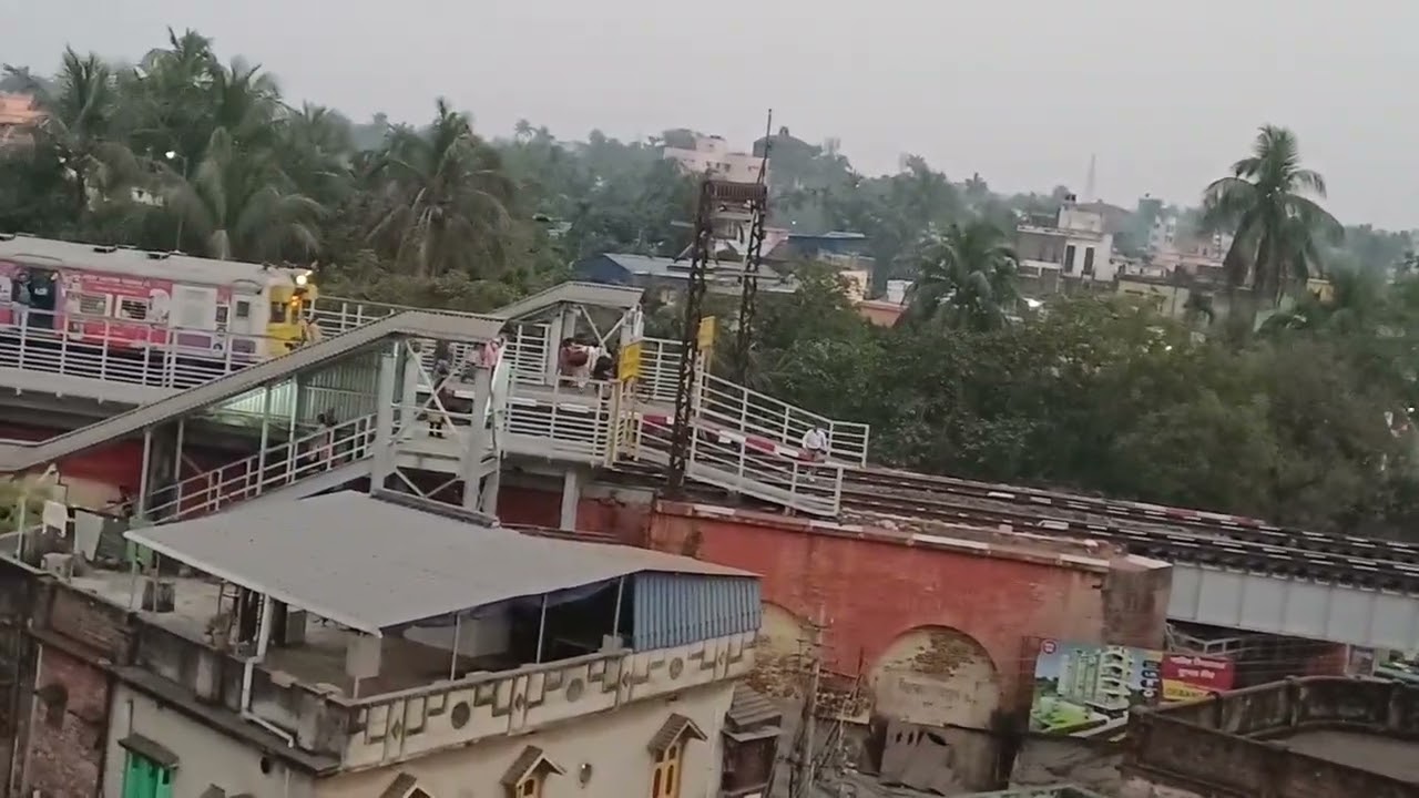 Up Naihati - Bandel local train is entering and leaving Hooghly Ghat Rly. Station.