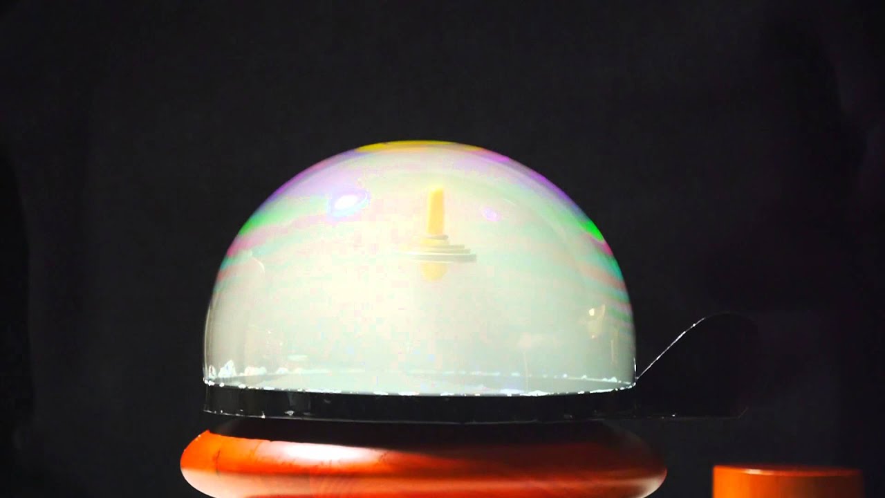 Levitating top in a smoke bubble