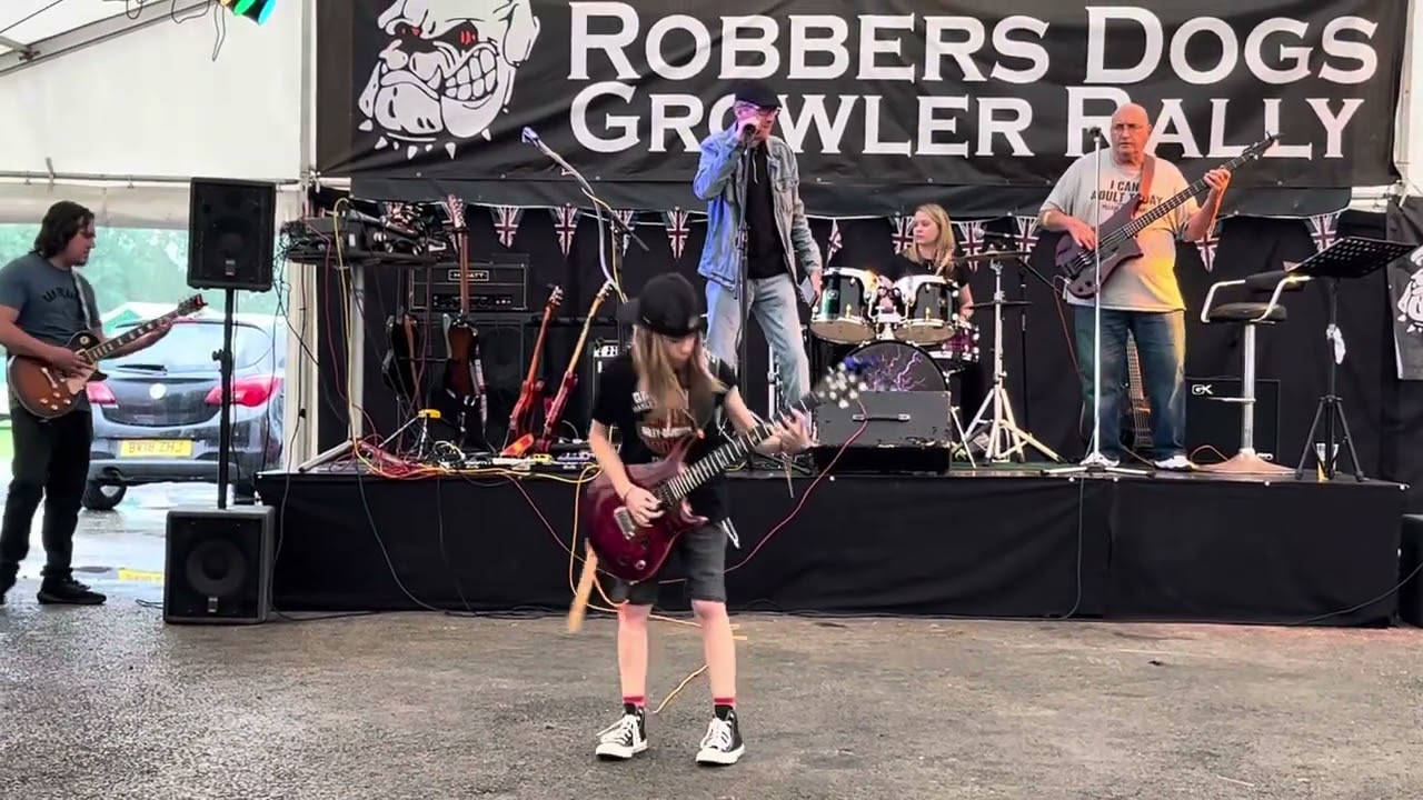 10 year old guitarist performs Whole Lotta Rosie ACDC with guitar & drum teachers like Angus Young