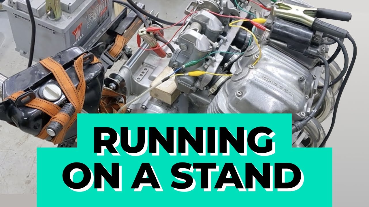 Honda CB750 engine and carbs running on a stand