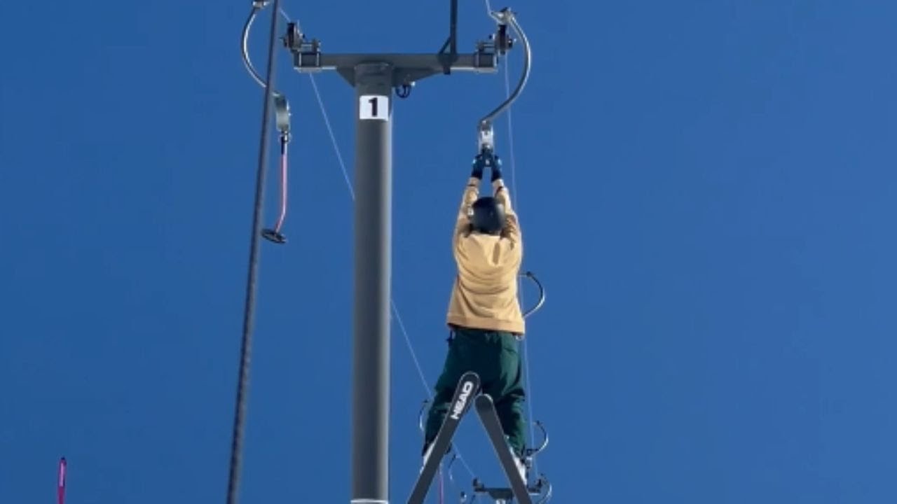 Fearless skier defies convention by hanging from a soaring lift || WooGlobe