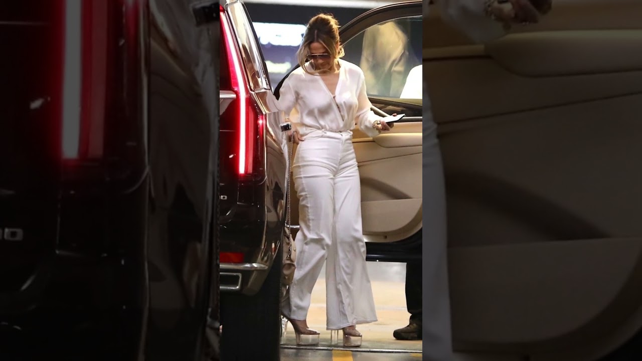 Jennifer Lopez's Chic Beverly Hills Look: White Trousers, Tucked Blouse & Valentino Handbag
