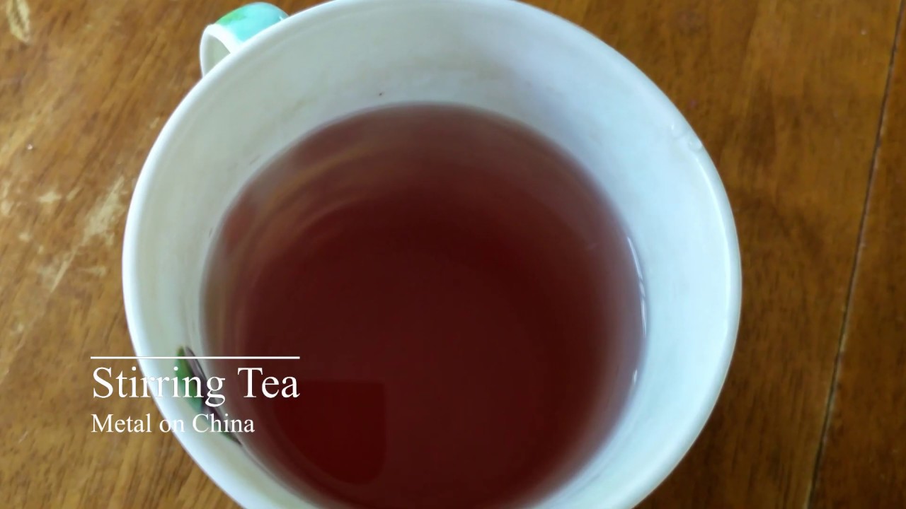 Stirring [ASMR] tea with metal spoon in a china mug