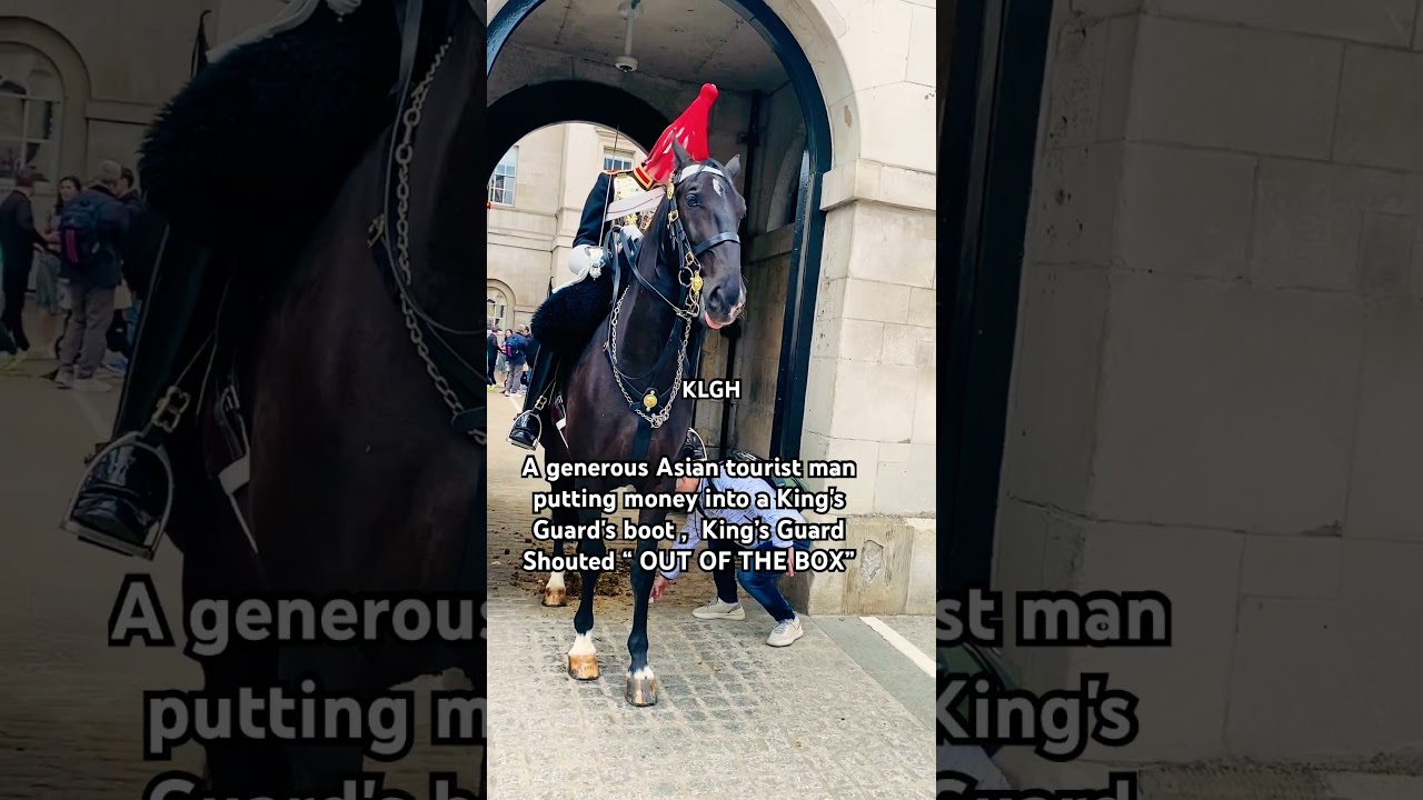 A generous tourist man  putting money into a King's Guard's boot King&rsquo;s Guard Shouted OUT OF THE BOX