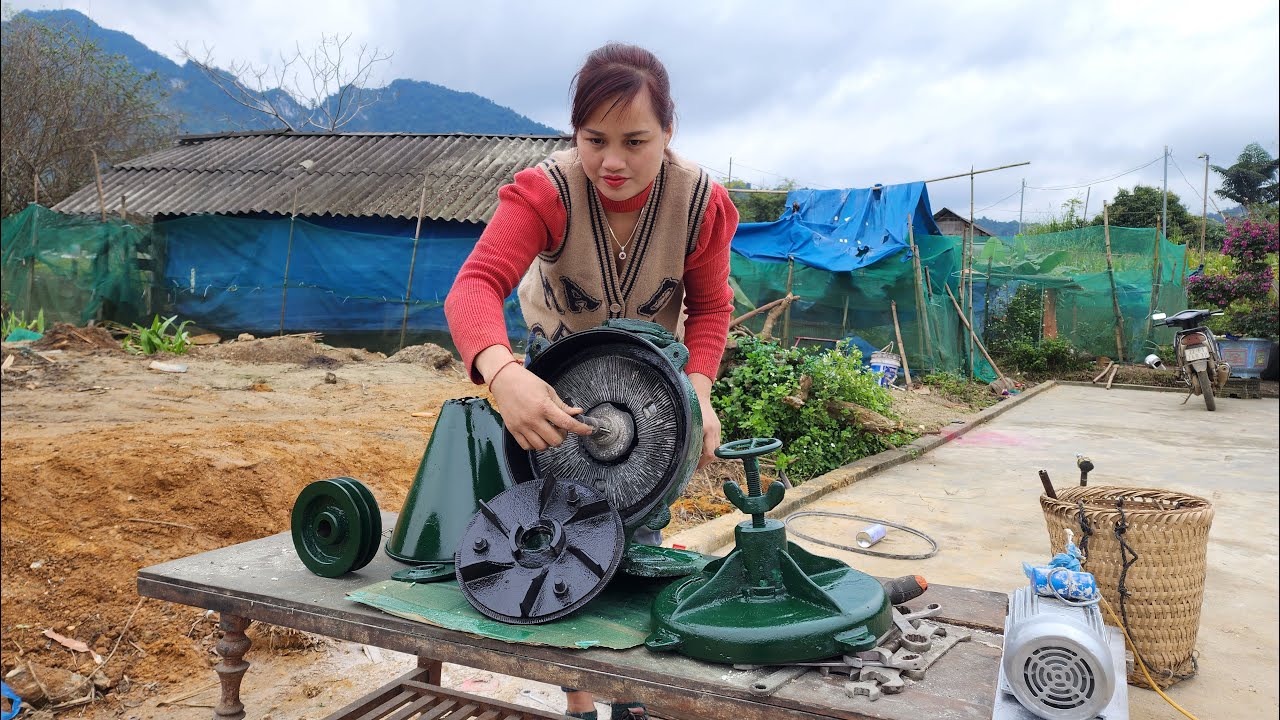 The genius girl repairs and maintains the corn grinding machine