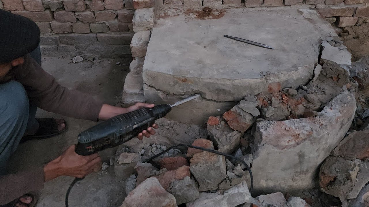Man Breaking Concrete Floor Side Using Drill Machine