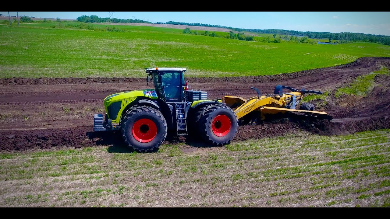 CLAAS XERION MOVING DIRT WITH AG SHIELD TERRAFORMER