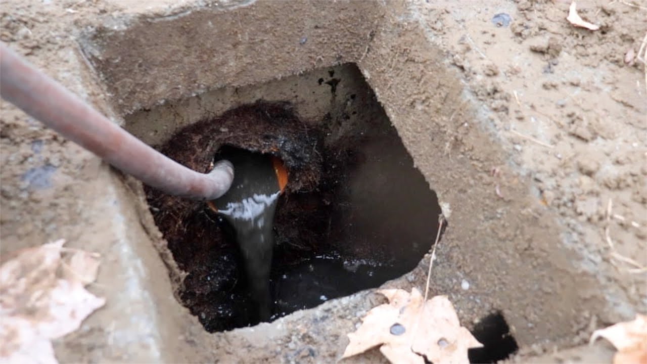 Locating a septic tank and clearing a clogged root bound sewer line